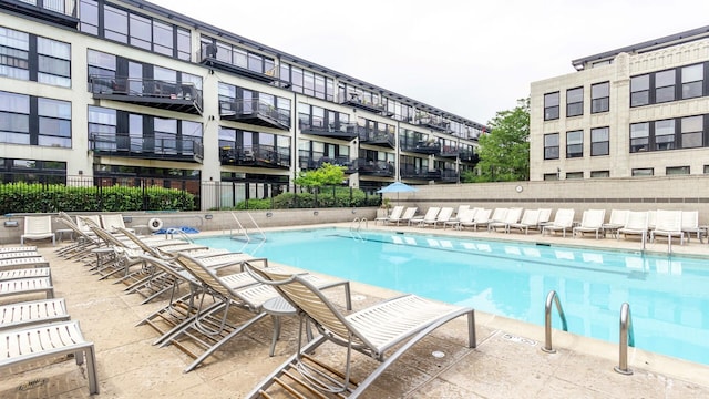 view of swimming pool with fence