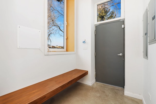 entrance foyer featuring baseboards and concrete flooring