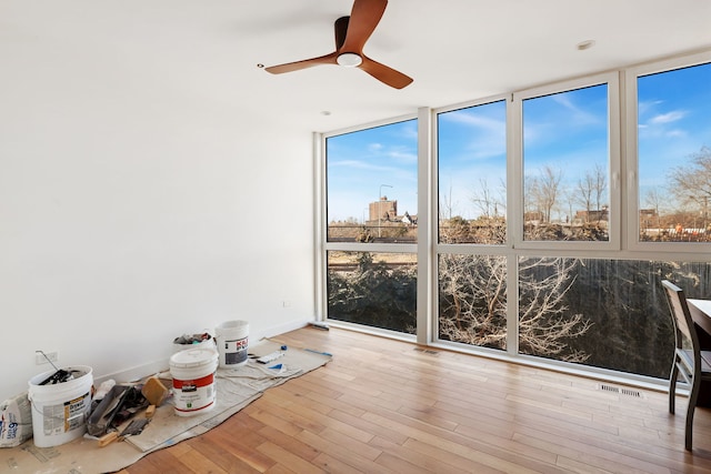 unfurnished sunroom with visible vents and ceiling fan