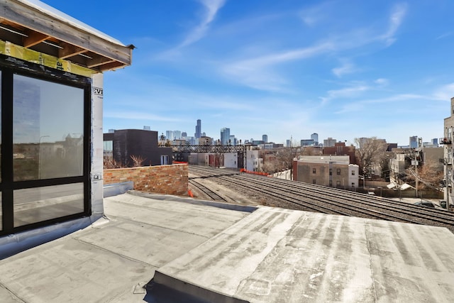 view of patio with a balcony and a city view