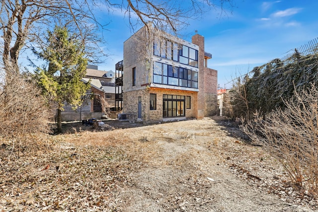 rear view of property with a chimney