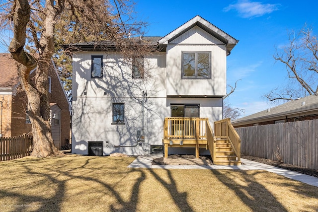 back of house featuring a yard and fence