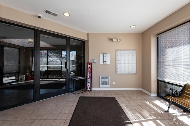 building lobby featuring heating unit and visible vents