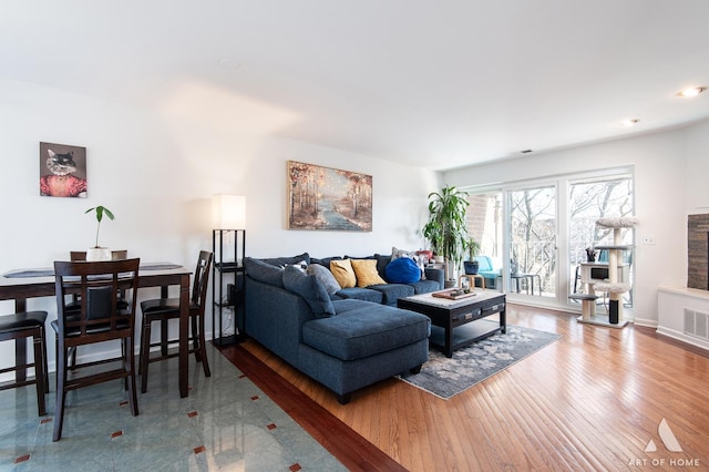 living room with baseboards and wood finished floors