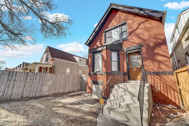 exterior space with a fenced backyard and brick siding