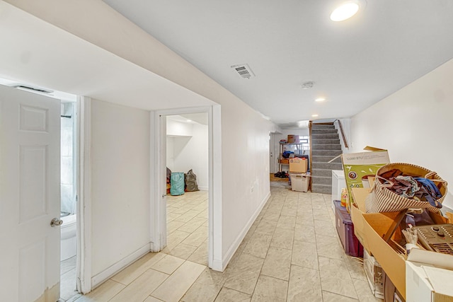 hallway with stairway, recessed lighting, baseboards, and visible vents