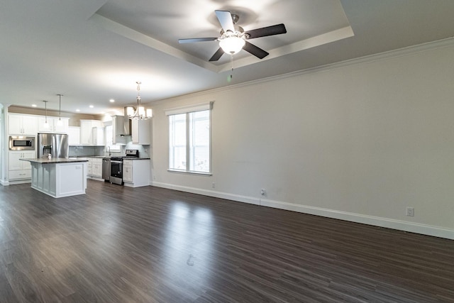 unfurnished living room with dark wood-style floors, baseboards, crown molding, and a tray ceiling