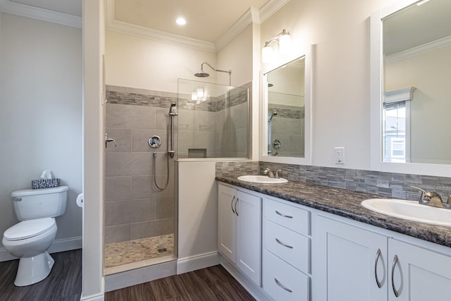 full bathroom featuring a sink, crown molding, and wood finished floors