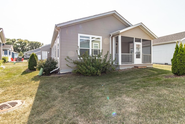 view of front of home featuring a front lawn and a sunroom