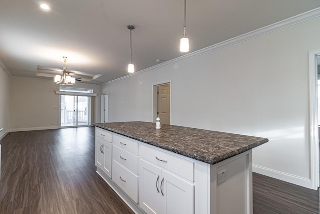 kitchen featuring a kitchen island, baseboards, ornamental molding, white cabinets, and dark wood-style flooring