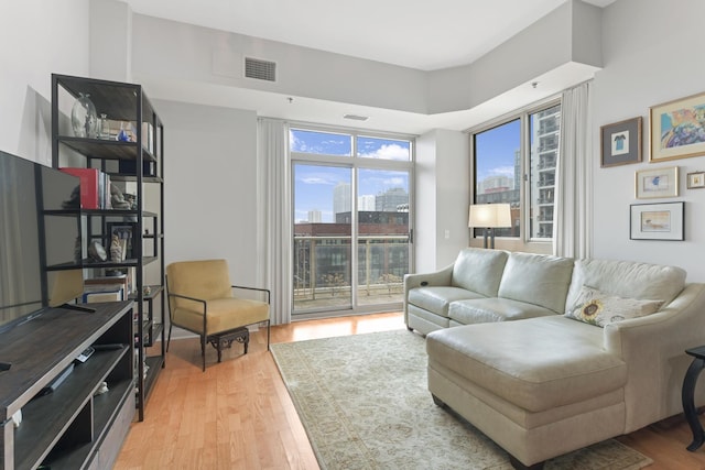 interior space featuring visible vents, a city view, and light wood-style flooring