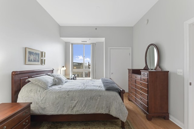 bedroom with baseboards and light wood-style flooring