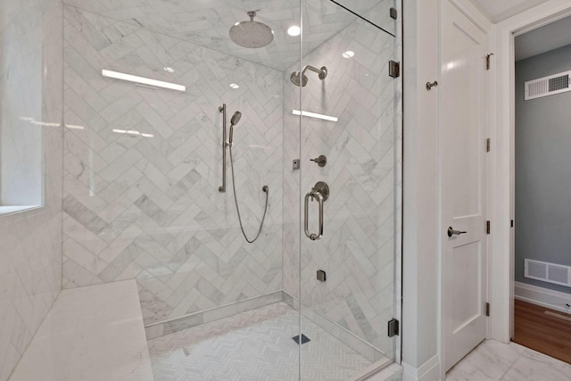 full bath with visible vents, baseboards, marble finish floor, and a stall shower