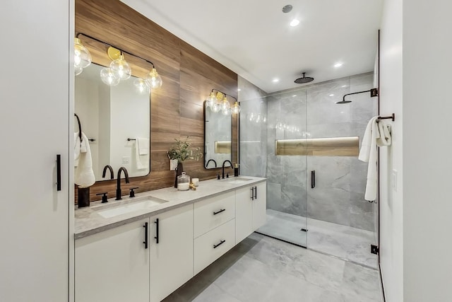 bathroom with double vanity, recessed lighting, a stall shower, and a sink