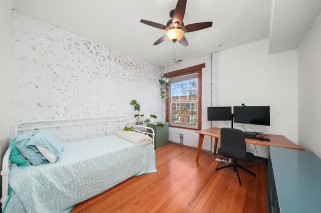 bedroom featuring wood finished floors and ceiling fan