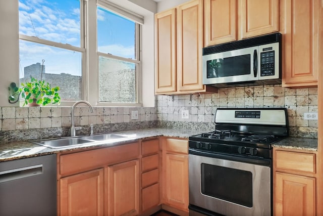 kitchen featuring a sink, light brown cabinets, backsplash, and stainless steel appliances