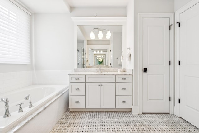 bathroom featuring vanity, a garden tub, and a shower with shower door