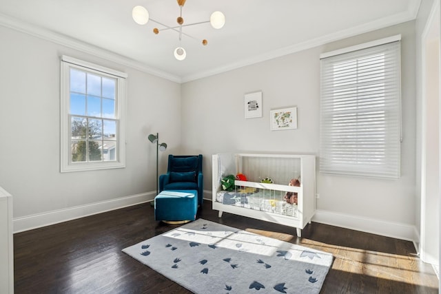 bedroom with wood finished floors, baseboards, and ornamental molding