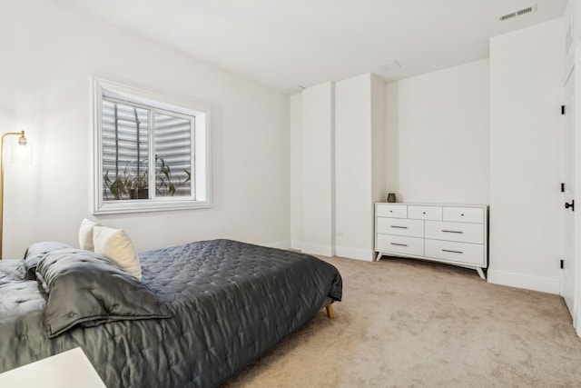 bedroom featuring light colored carpet, visible vents, and baseboards