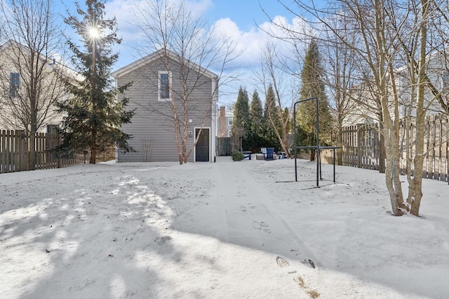 snowy yard featuring fence