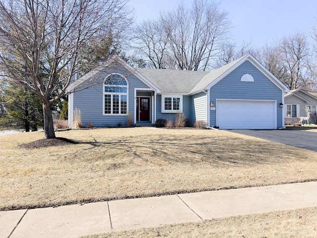 single story home with aphalt driveway, an attached garage, and roof with shingles