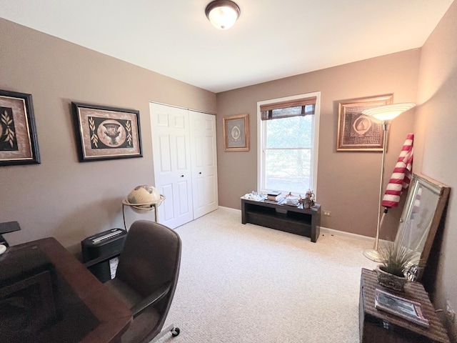 home office with baseboards and light carpet