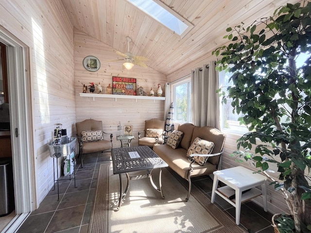 interior space featuring vaulted ceiling with skylight, wood ceiling, wood walls, and dark tile patterned flooring