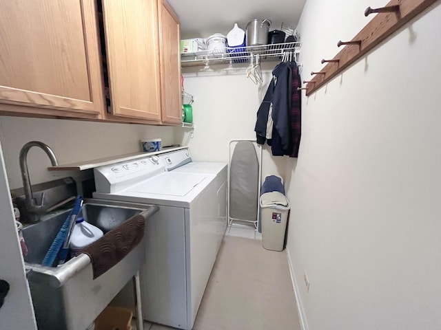 laundry area with washer and dryer, cabinet space, and baseboards