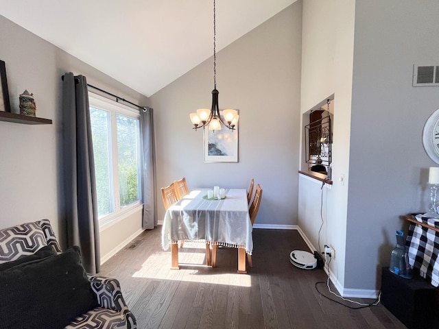 dining area featuring visible vents, a notable chandelier, high vaulted ceiling, wood finished floors, and baseboards