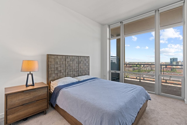 bedroom with light carpet, access to exterior, and floor to ceiling windows