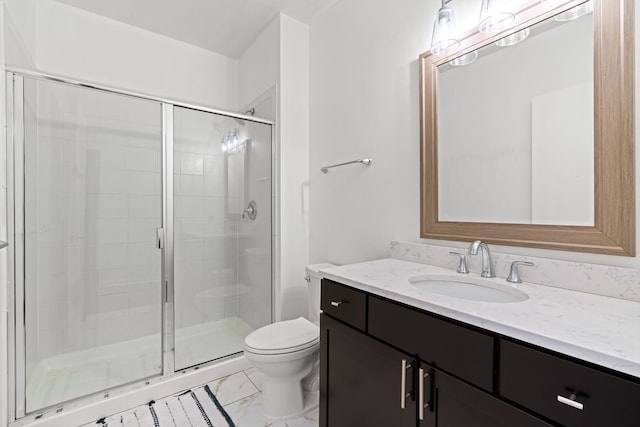 bathroom with vanity, toilet, a stall shower, and marble finish floor