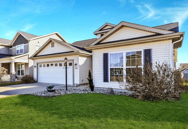 view of front of home with an attached garage, concrete driveway, and a front yard