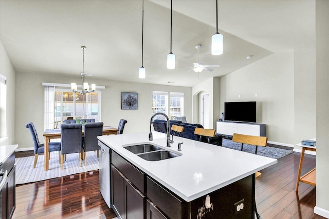 kitchen featuring dishwasher, light countertops, dark wood-style floors, and a sink