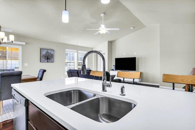 kitchen with open floor plan, dishwasher, light countertops, and a sink