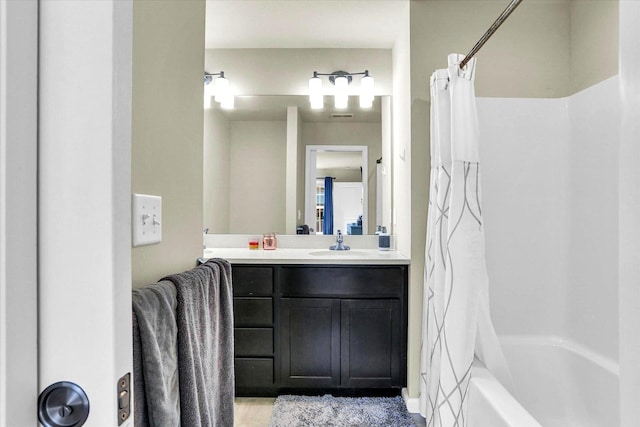 bathroom featuring shower / bathtub combination with curtain, visible vents, and vanity