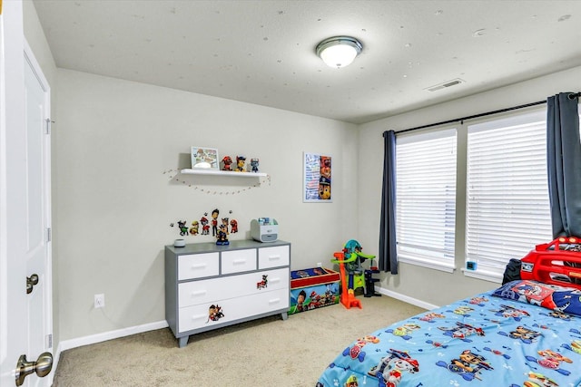 carpeted bedroom with visible vents and baseboards