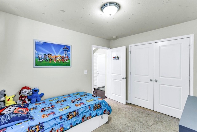 bedroom featuring a closet and carpet floors