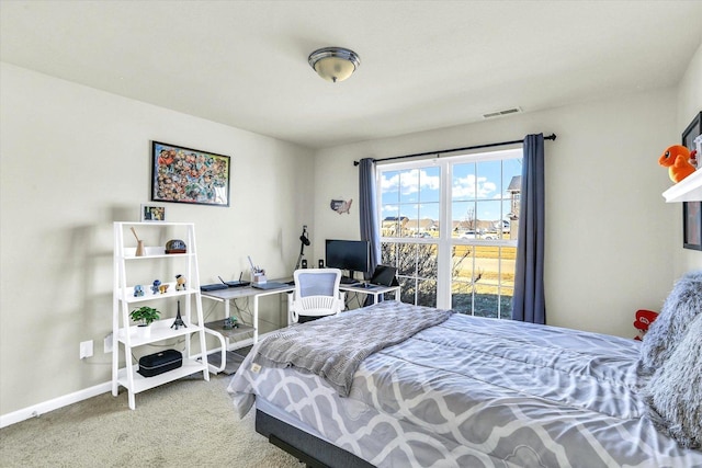 carpeted bedroom with visible vents and baseboards