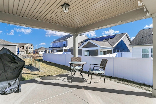 view of patio with a residential view and fence