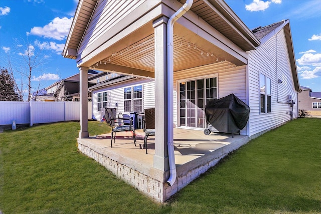 view of patio / terrace with a grill and fence