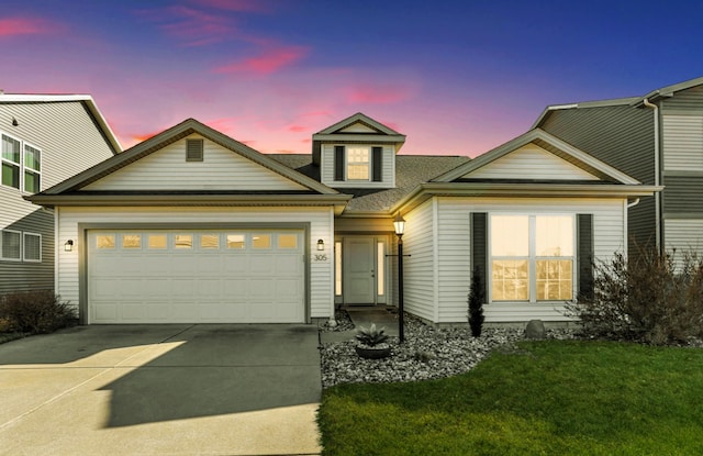 view of front of property featuring concrete driveway and a garage