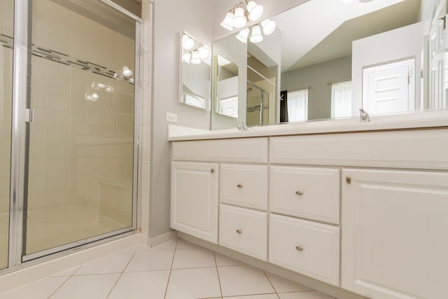 full bath with tile patterned floors, a stall shower, and double vanity