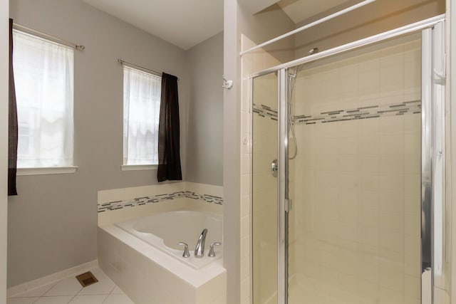 full bathroom featuring tile patterned flooring, a shower stall, baseboards, and a garden tub