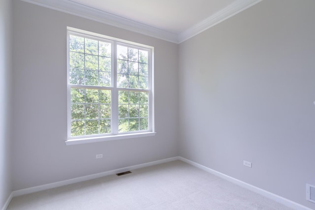 unfurnished room with baseboards, light carpet, visible vents, and ornamental molding