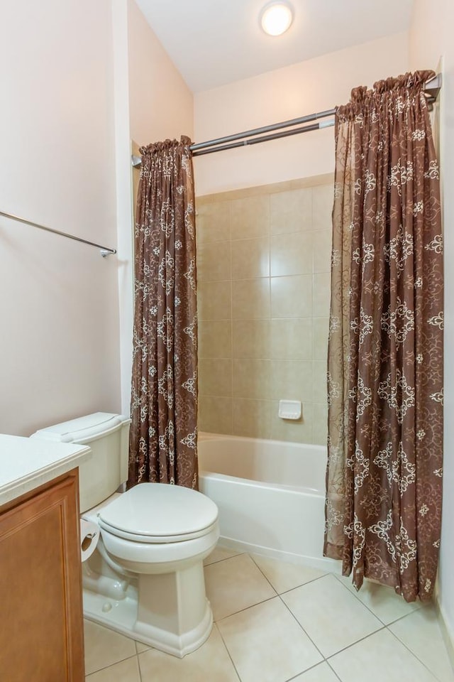 bathroom with vanity, toilet, shower / tub combo with curtain, and tile patterned flooring