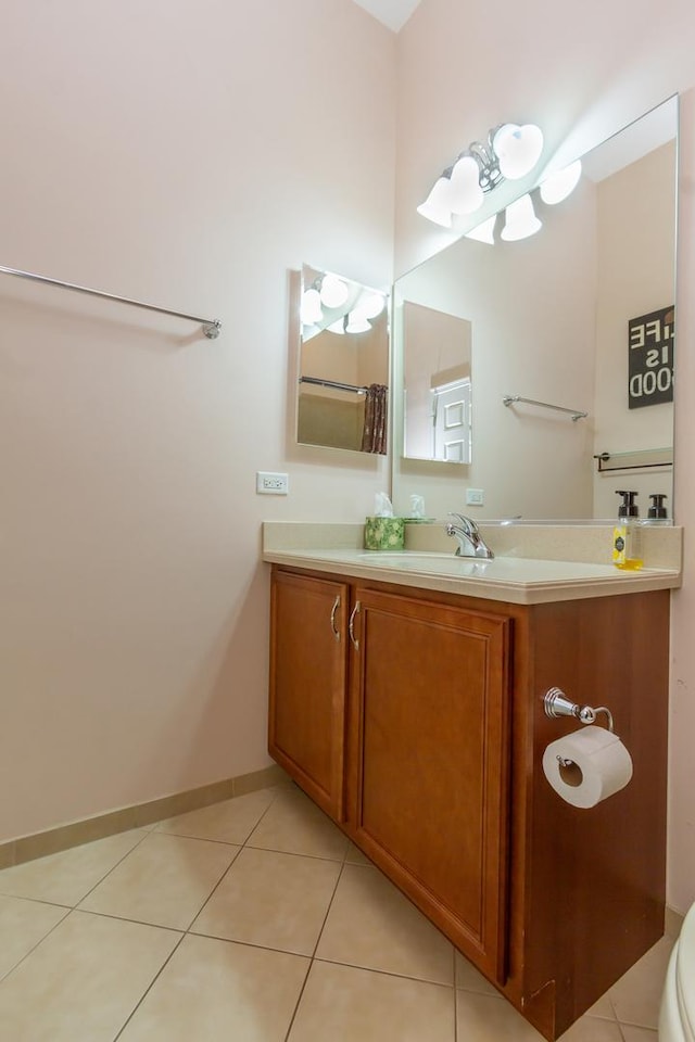 bathroom with vanity, tile patterned floors, toilet, and baseboards