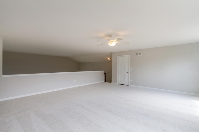 empty room featuring visible vents, baseboards, light carpet, and a ceiling fan