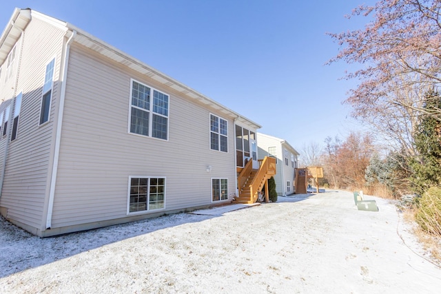 rear view of property featuring stairs