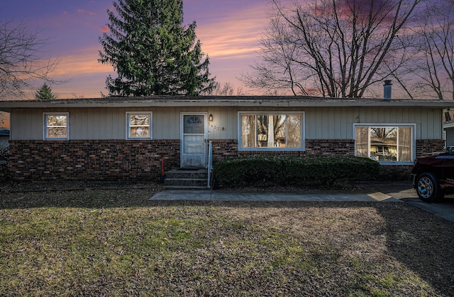 view of front of property with brick siding and a front lawn