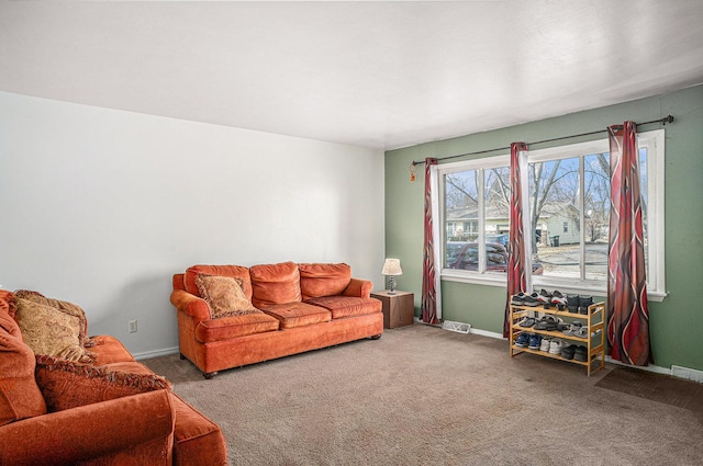 carpeted living room featuring visible vents and baseboards